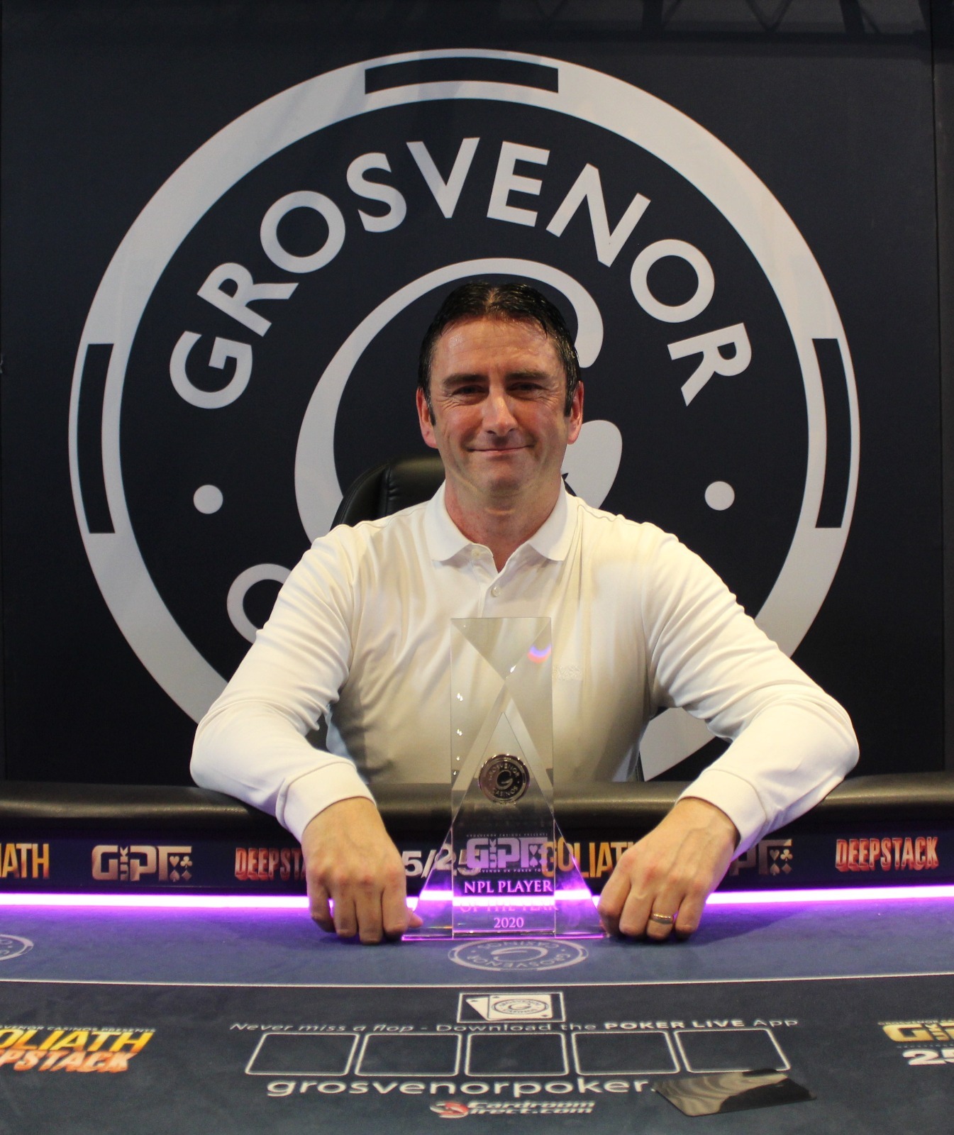 Person wearing a jacket and appearing focusing while playing casino game