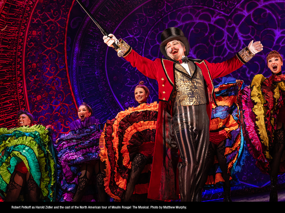 Robert Petkoff as Harold Zidler and the cast of the North American tour of “Moulin Rouge! The Musical.” (Photo courtesy of Matthew Murphy)