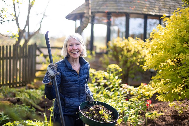Lady Gardening and smiling in the sunshine