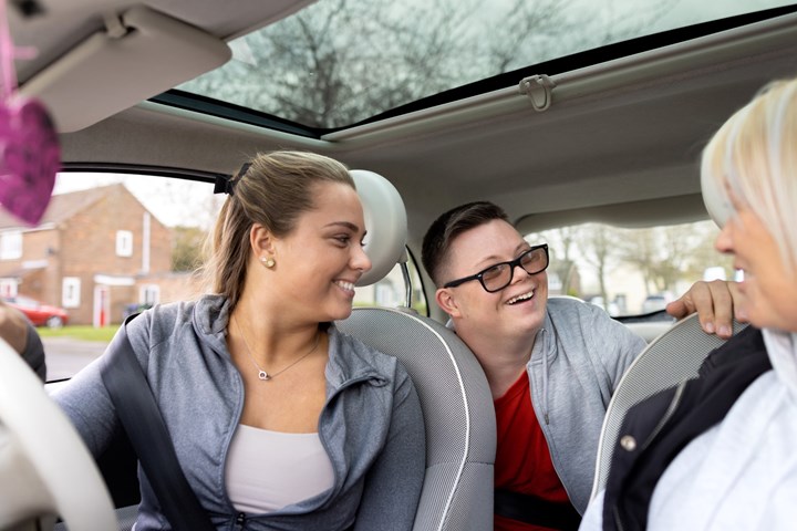 3 people laughing in a new car