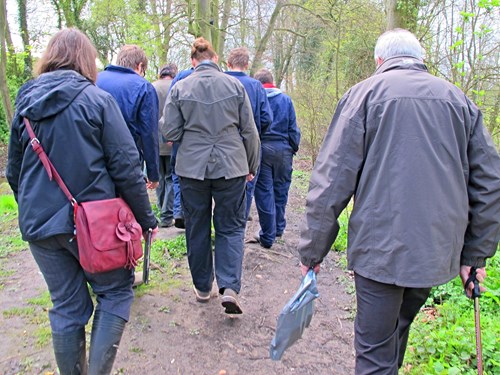 A group of people walking together along a trail path