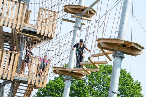 People walking through net high trails