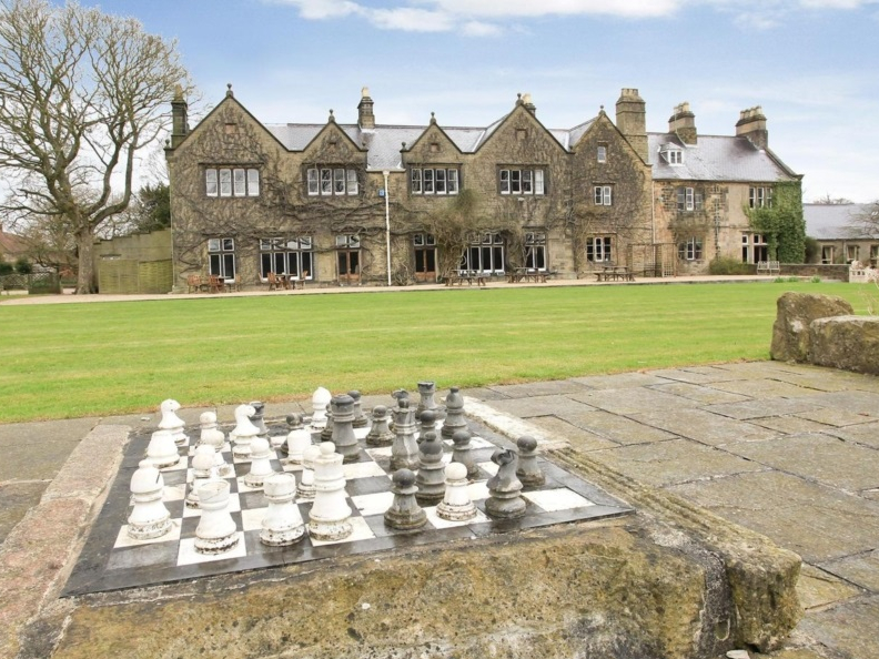 A large chess board on the ground outside the building of Teversal Manor House