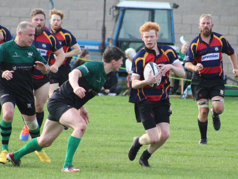 A rugby player attempts to tackle an Ashfield RUFC player with other team members around them