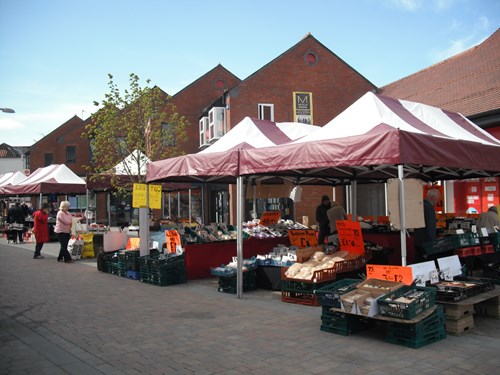 Stalls and customers at Kirkby Outdoor Market