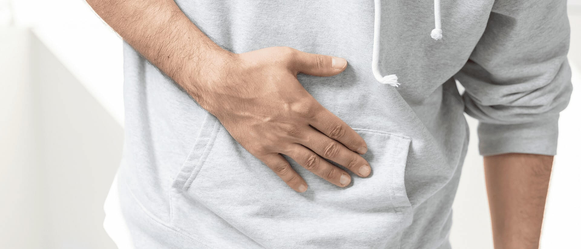 Person with hand on stomach 