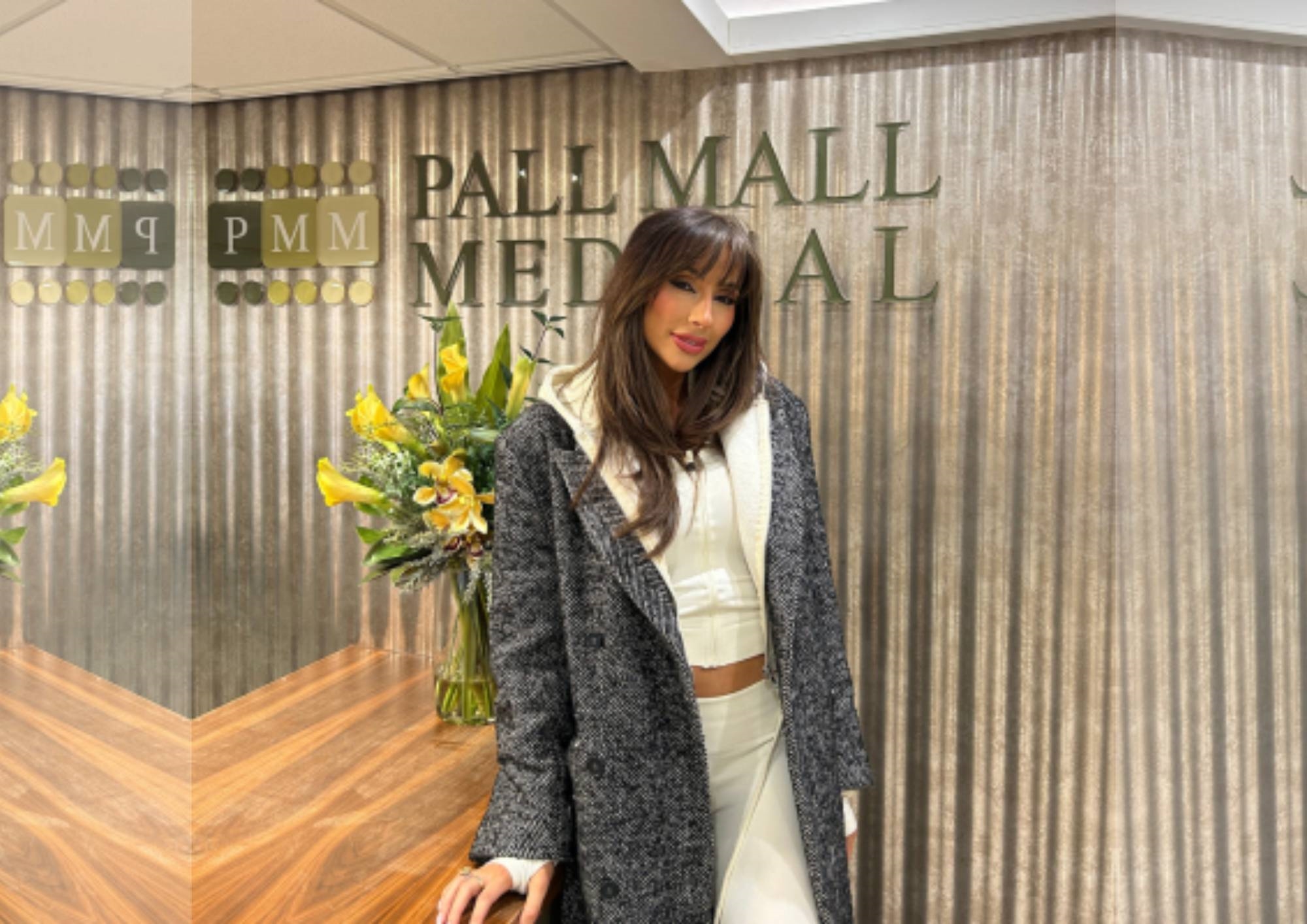 Woman posing at a reception desk