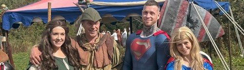 4 people dressed in Robin Hood and Superman costumes