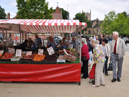 Customers gather at the fruit and vegetable stall at Hucknall Outdoor Market