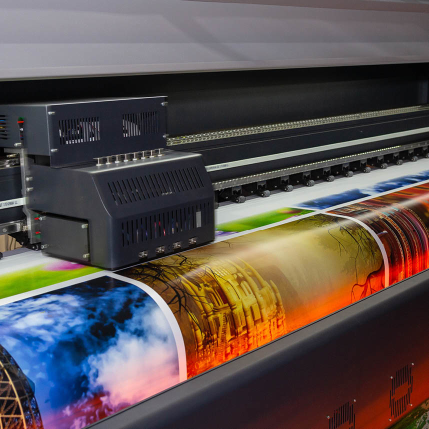 Large format printing machine producing colorful high-resolution graphics on a wide sheet.