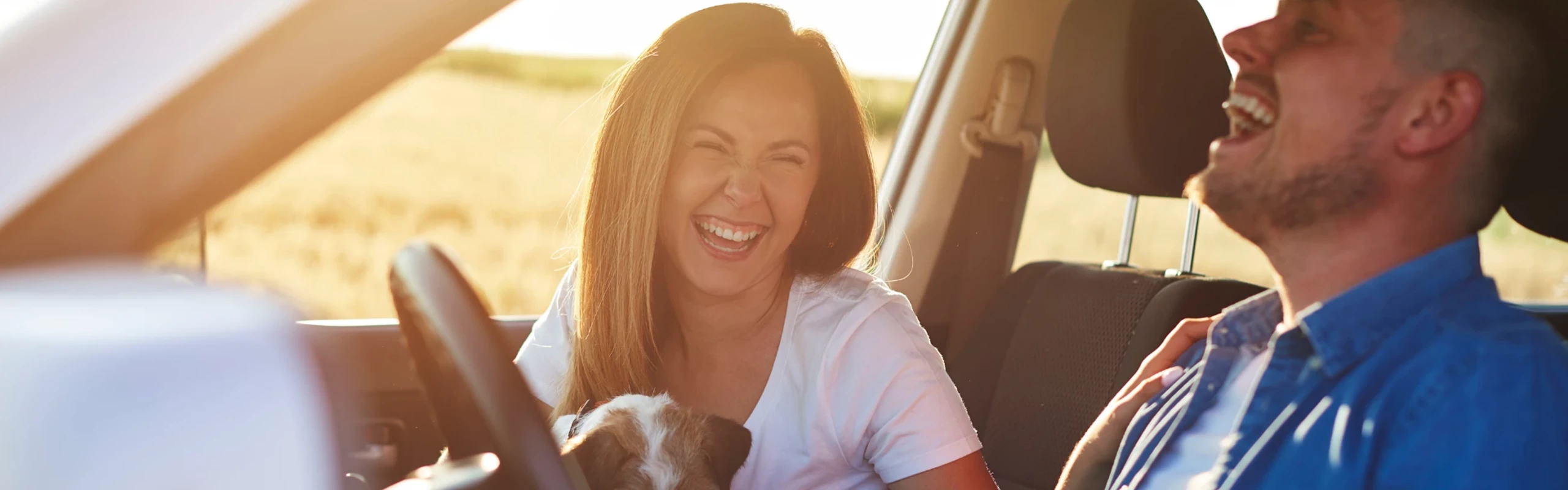 Couple in car smiling and laughing together