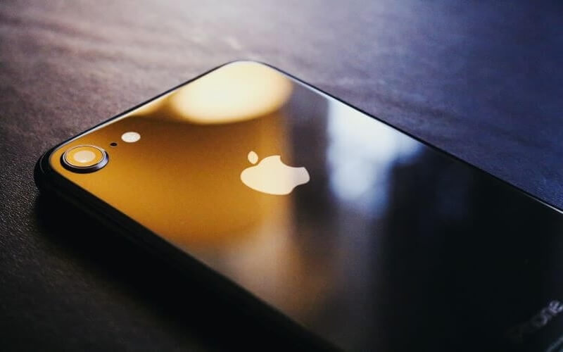 A black shiny iPhone model lay on a table