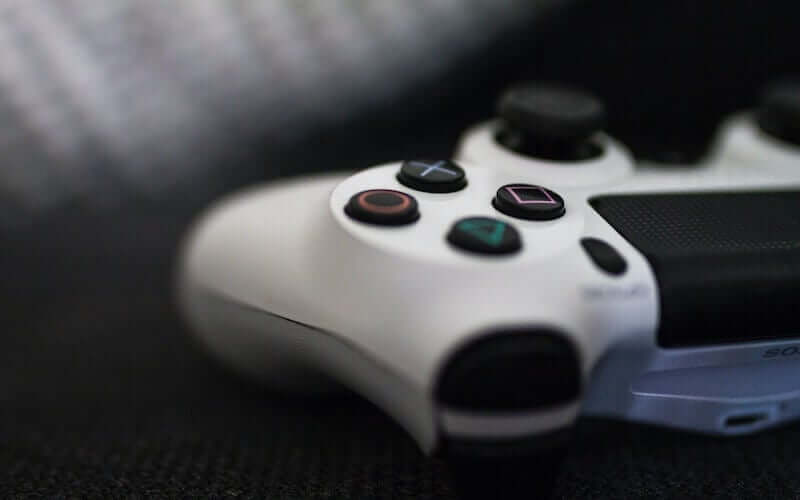 A close up of a white PS4 controller 