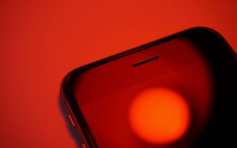 An iPhone with a red overlay