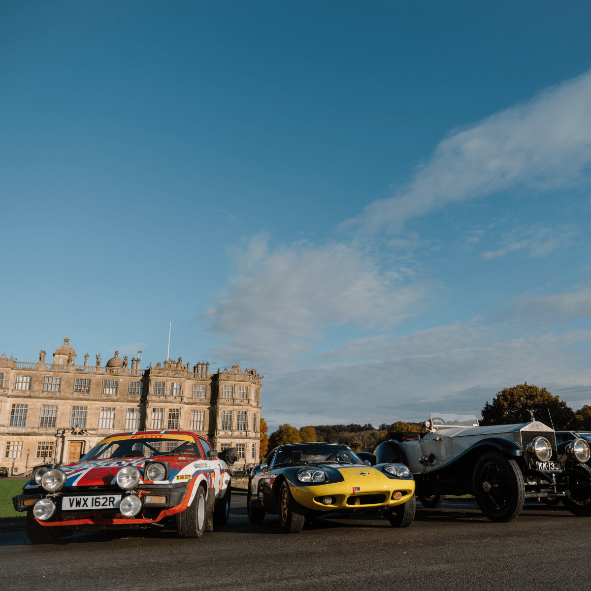 Three cars parked in front of Longleat House to promote the Motor Show Weekender