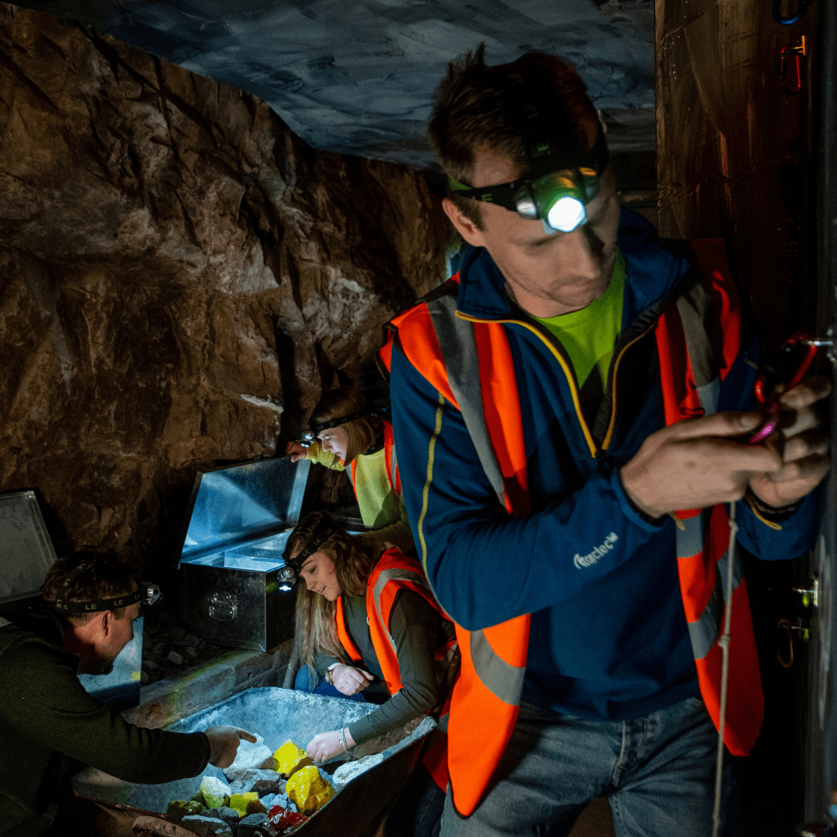 A man in the escape rooms at cheddar attempts to unlock a padlock using a code
