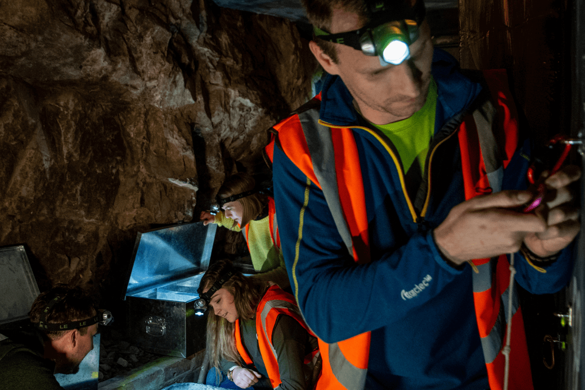 A man in the escape rooms at cheddar attempts to unlock a padlock using a code