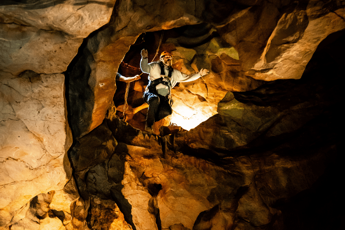 A visitor jumps from the drop during the Black Cat Freefall, with arms outstretched.