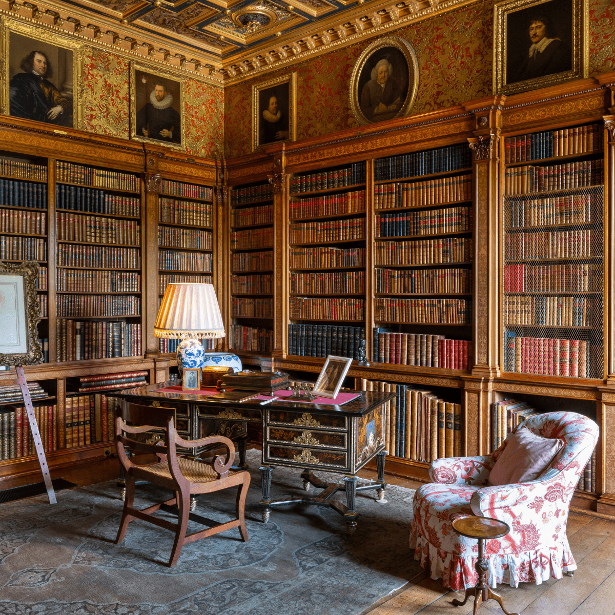 A wide shot of one of the Longleat libraries, with books, art and furniture on display