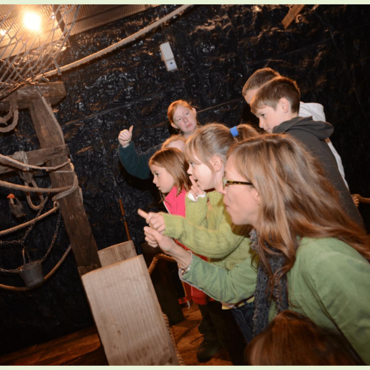Children in bat cave with keeper