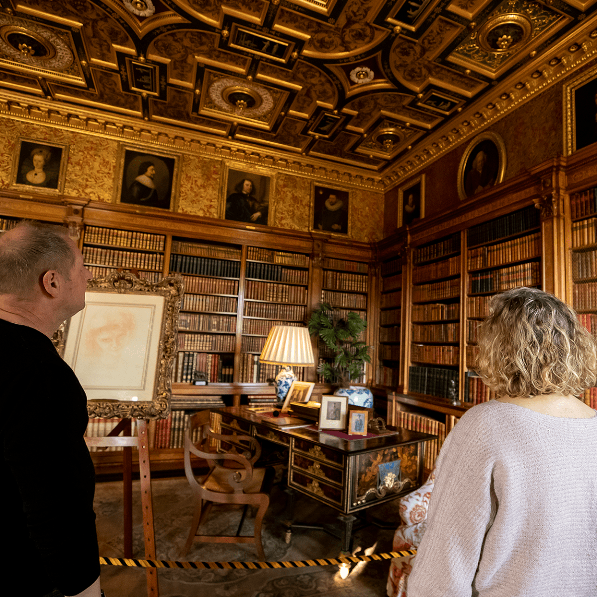 Two visitors admire one of the grand rooms of Longleat House
