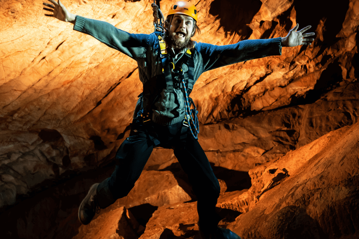 A visitor jumps from the drop during the Black Cat Freefall, with arms outstretched and a big grin.