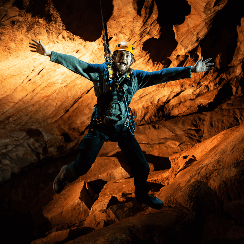 A visitor jumps from the drop during the Black Cat Freefall, with arms outstretched and a big grin.