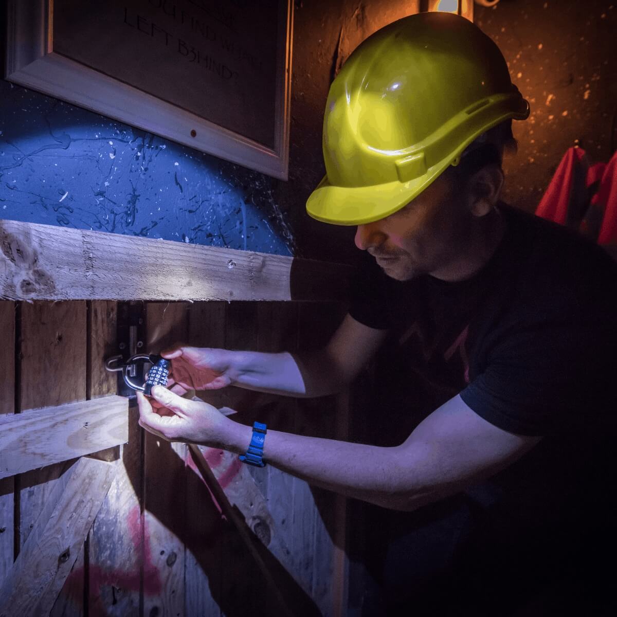 A man looks at a potential clue in a family escape room at Cheddar gorge in somerset near Bristol. He peers at a map looking for answers