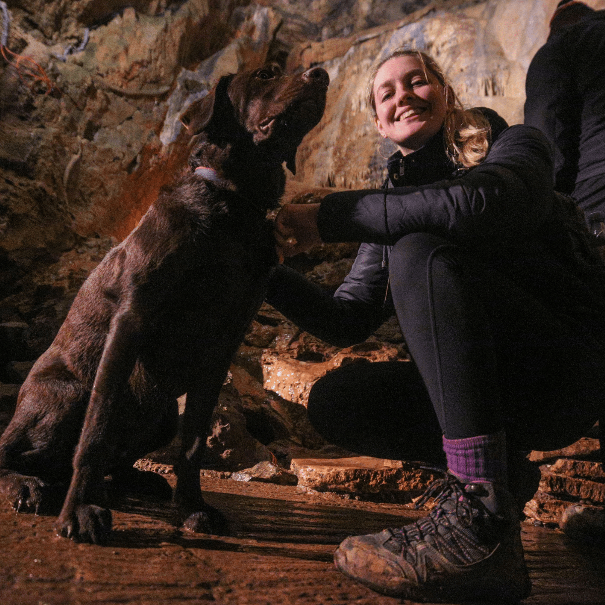 A dog and owner in Gough's Cave at Cheddar