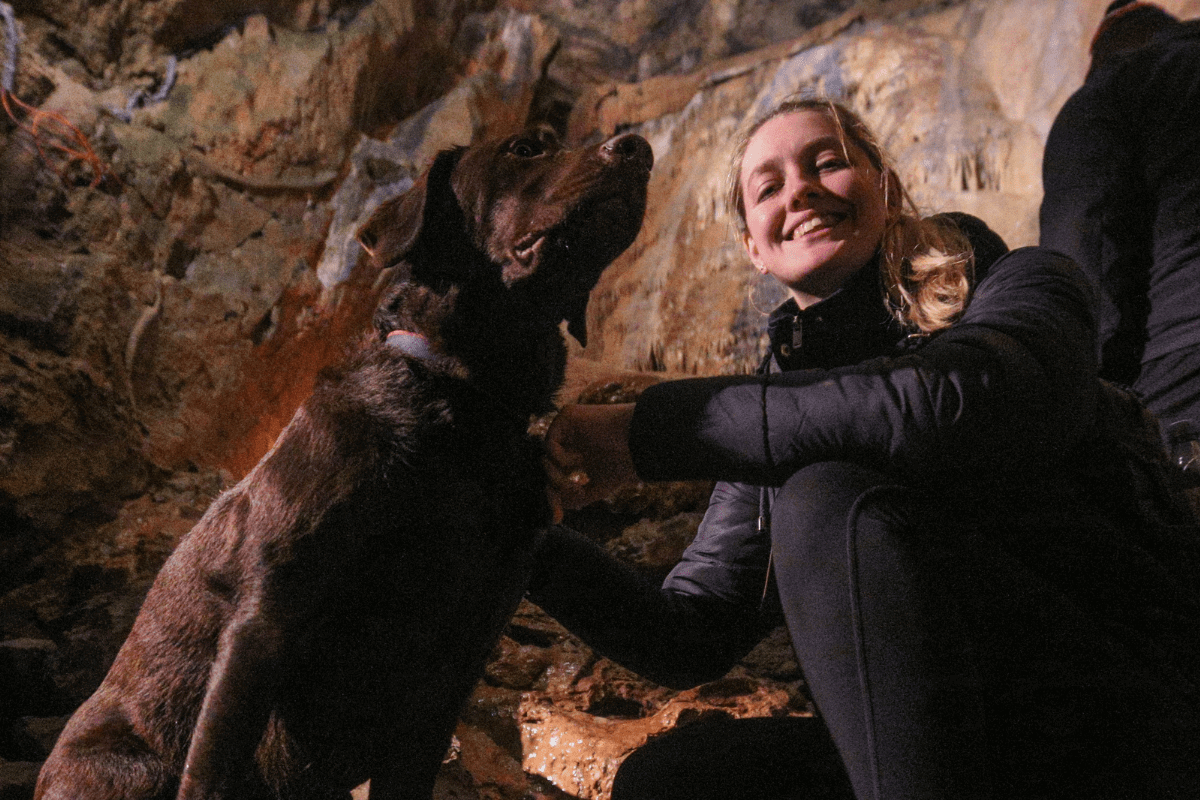 A dog and owner in Gough's Cave at Cheddar
