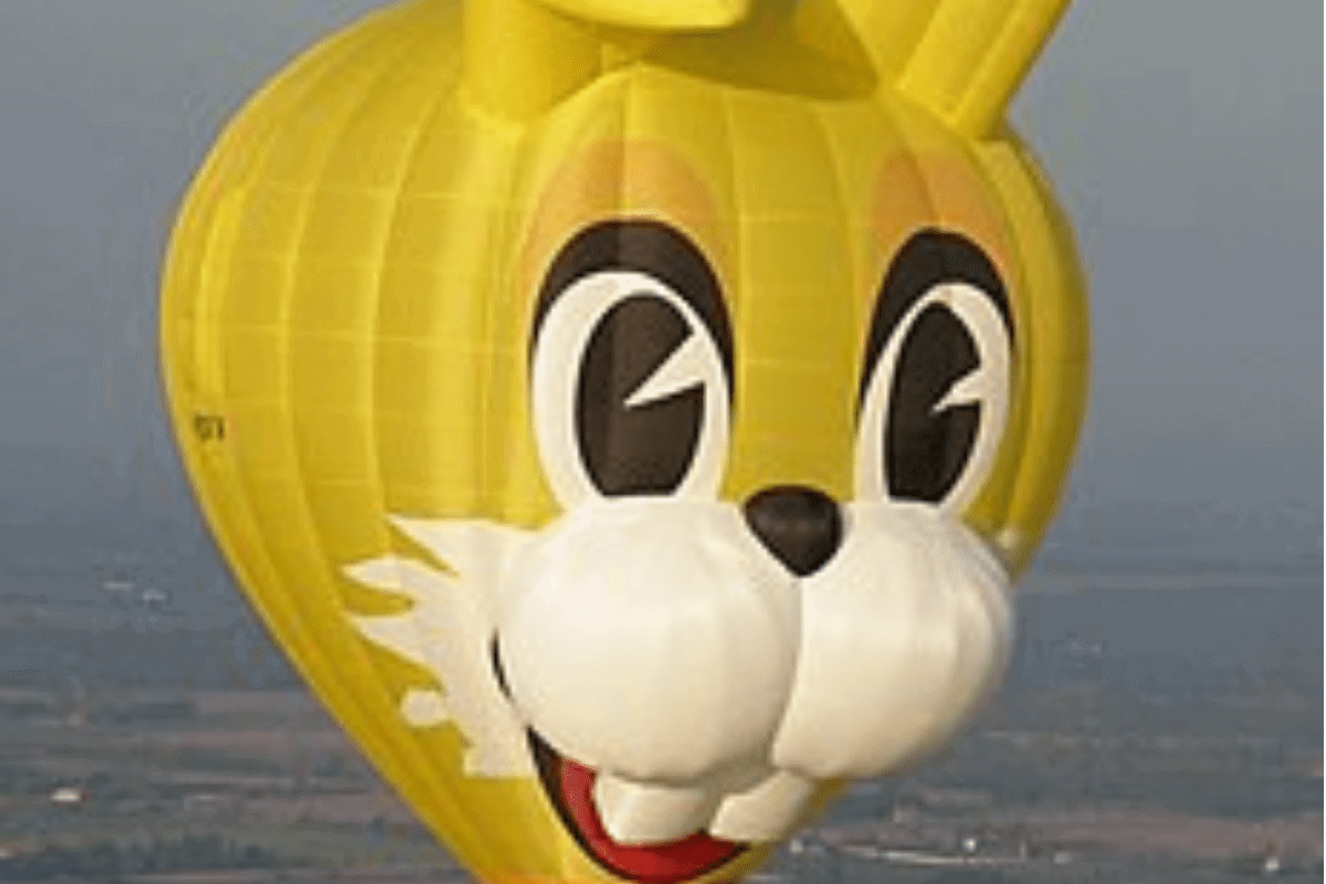 A rabbit-shaped balloon in bright yellow with friendly, happy face