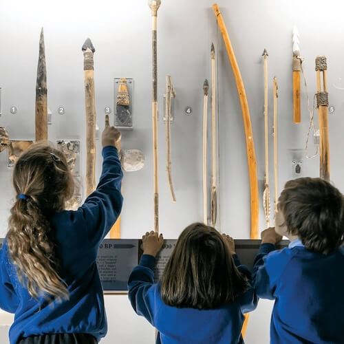 Young school children admire exhibit in the museum of prehistory at cheddar gorge and caves in somerset