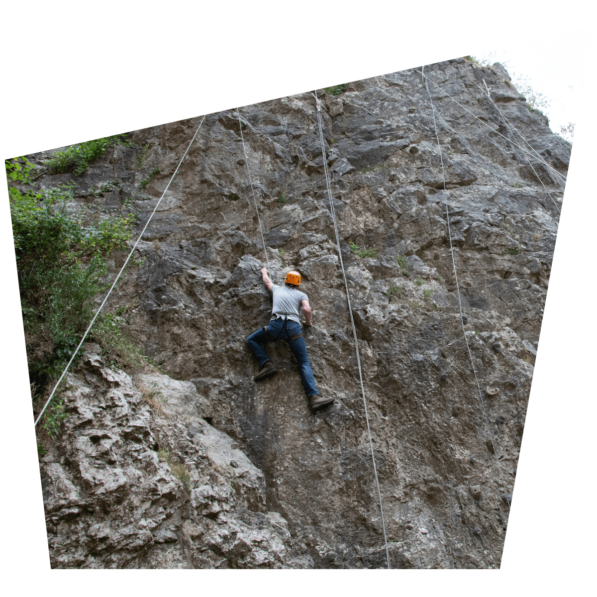 A visitor scales one of the rock formations at Cheddar Gorge & Caves