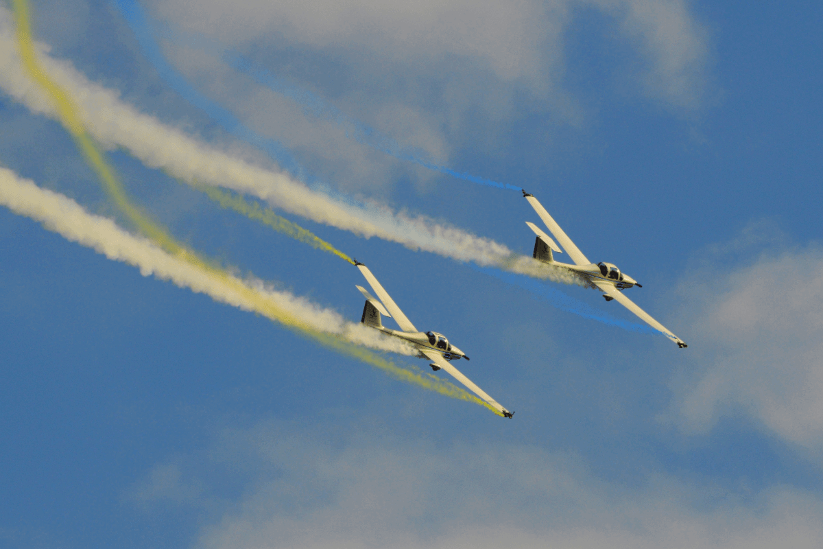 Two planes flying against a blue sky