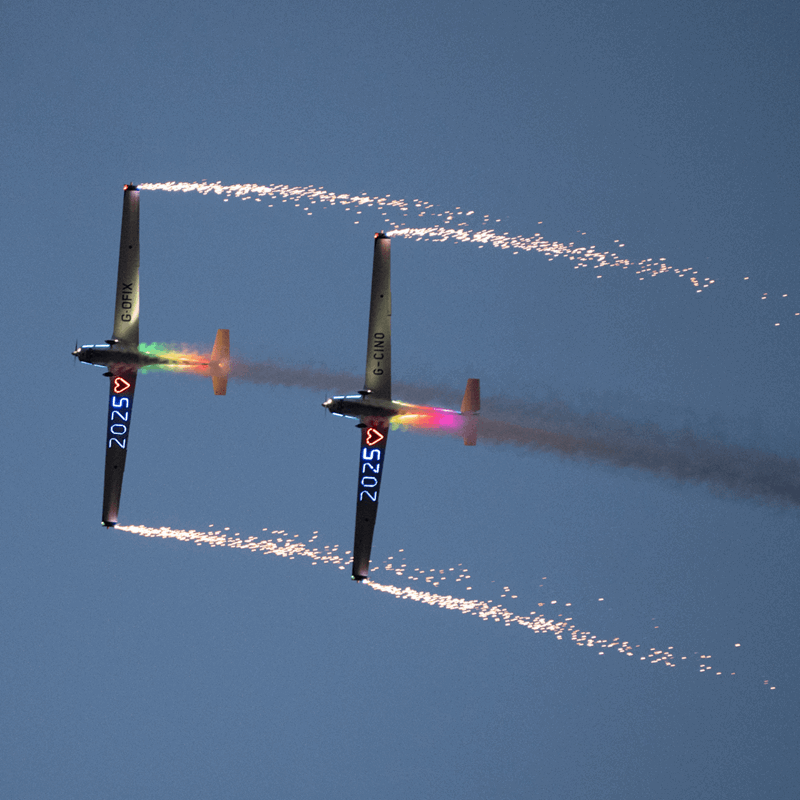 two rainbow planes with fireworks shooting out of the wings