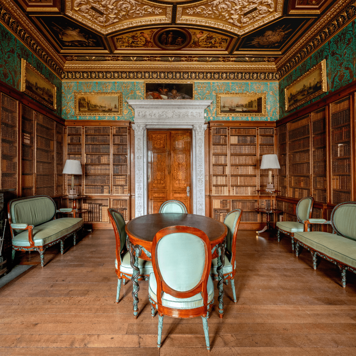 A wide shot of the green library with books, art and furniture on display