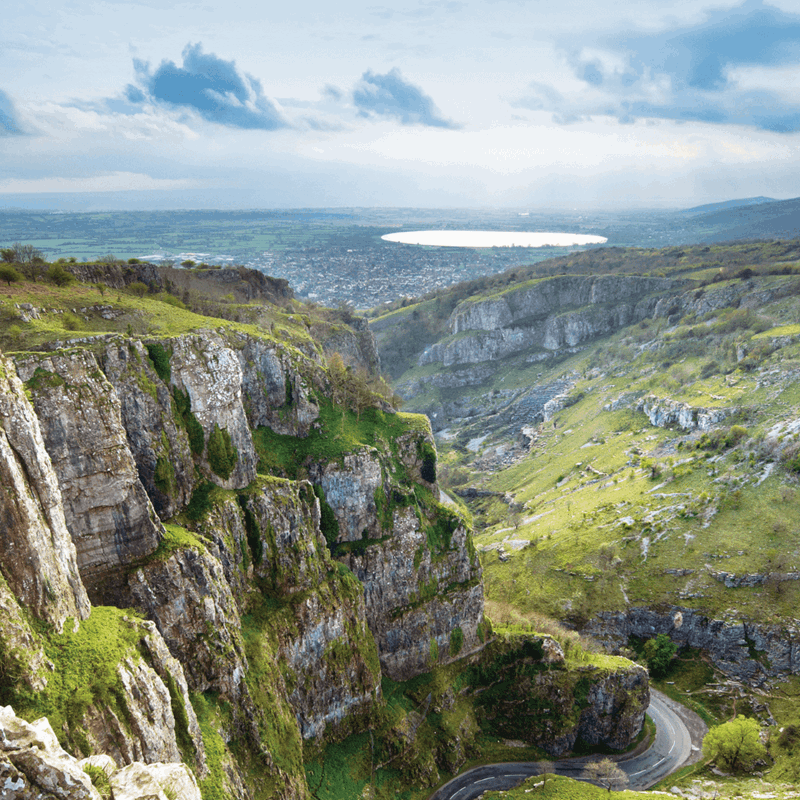 A look out into the lush and vast landscape of cheddar gorge and down into the winding roads below
