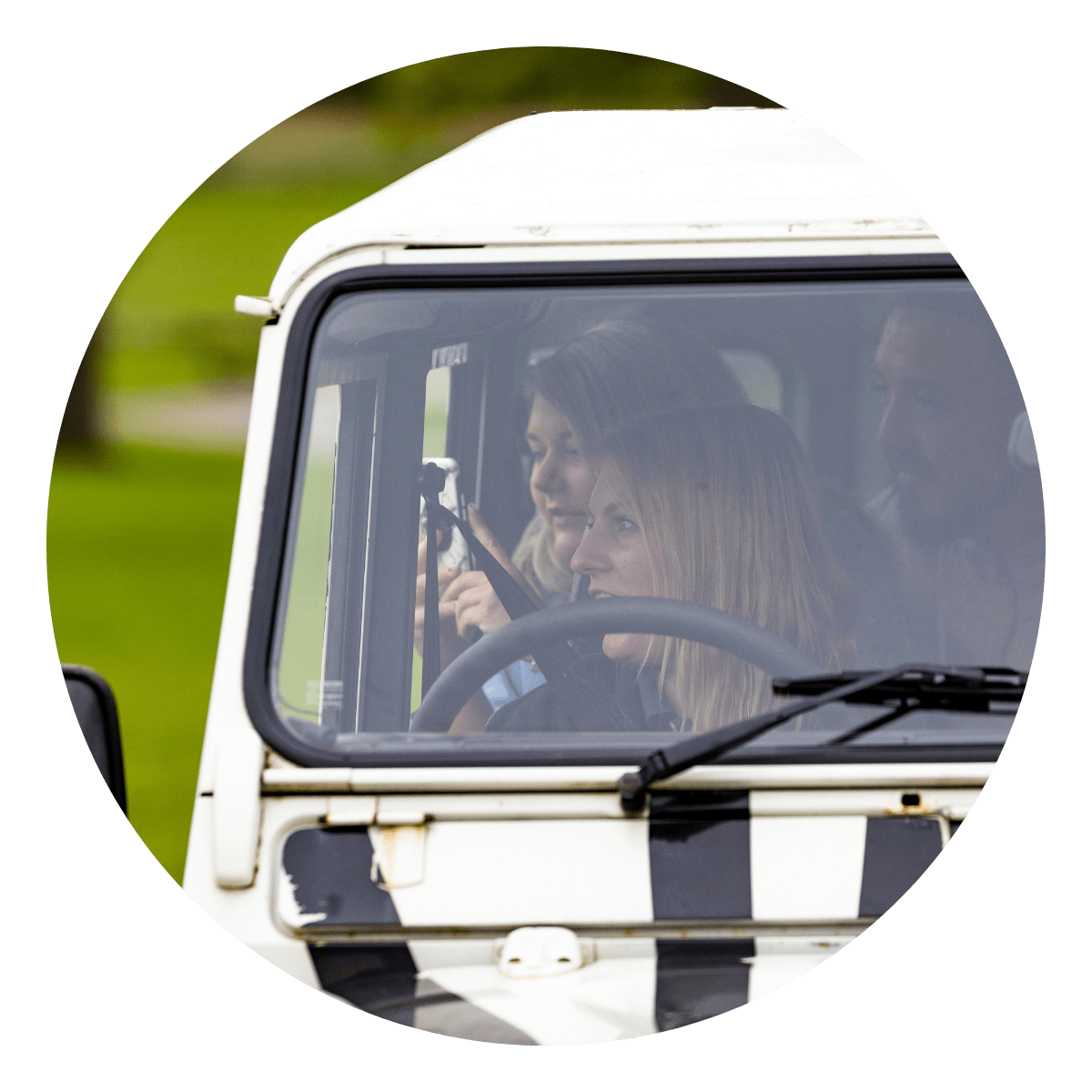 Guests in the iconic 4x4 zebra print VIP truck taking photographs of the safari