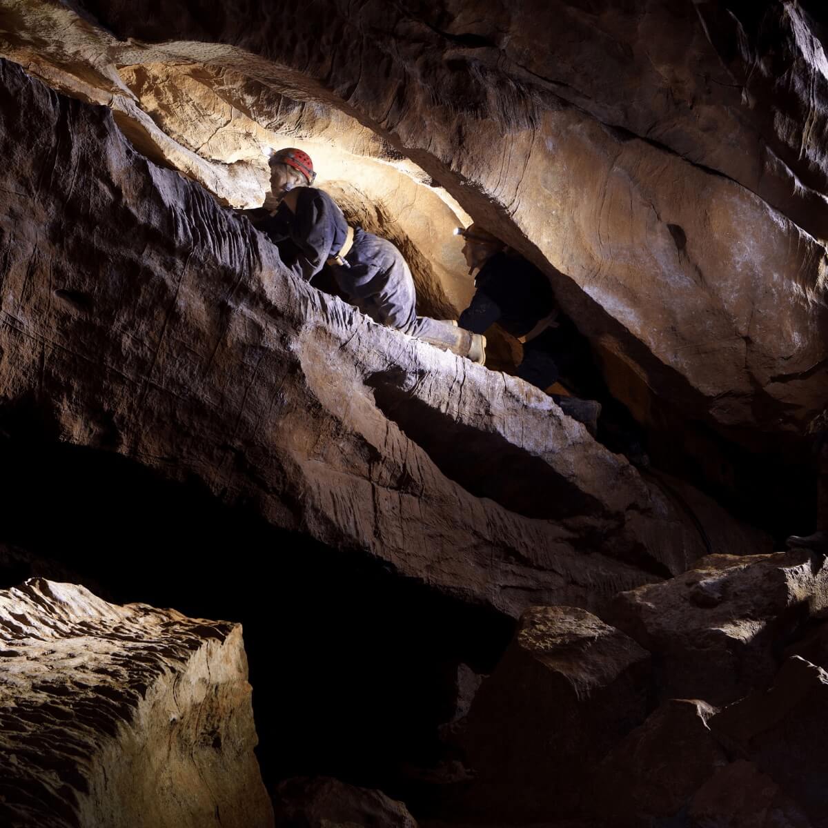 An adventure caver enjoying the caving activity in Gough's cave at Cheddar gorge