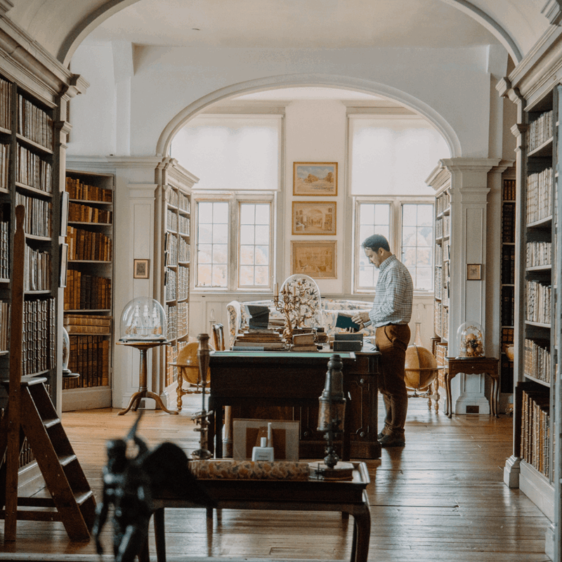 A glimpse of the Old library, with books lining the walls and intriguing artifacts on display