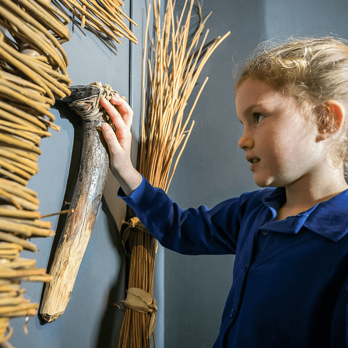 A young girl taking interest in the history exhibits
