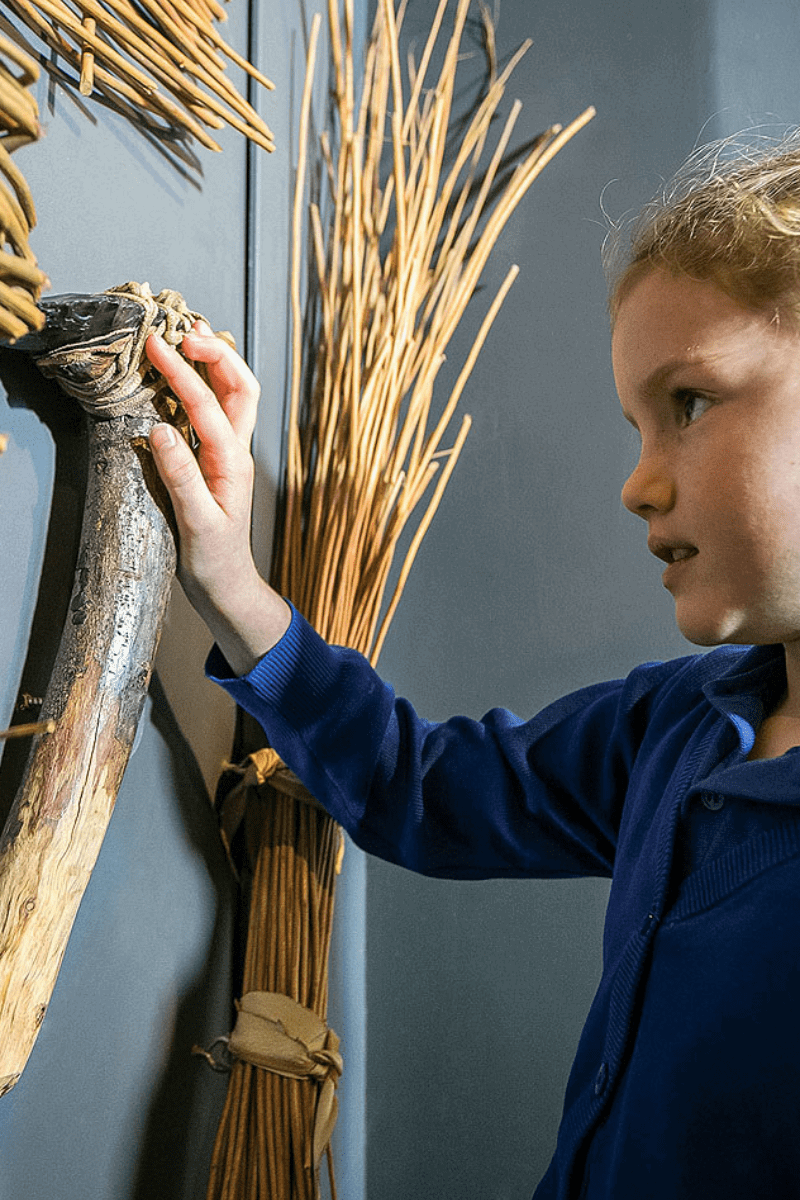 A young girl taking interest in the history exhibits