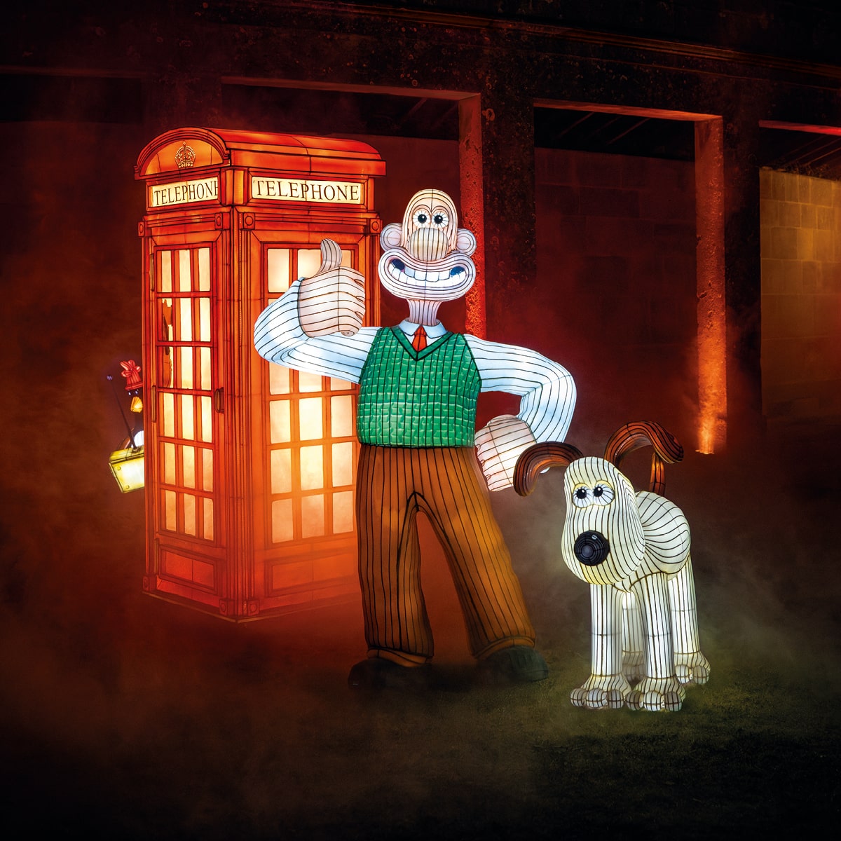 Wallace & Gromit silhouette in front of iconic red telephone box