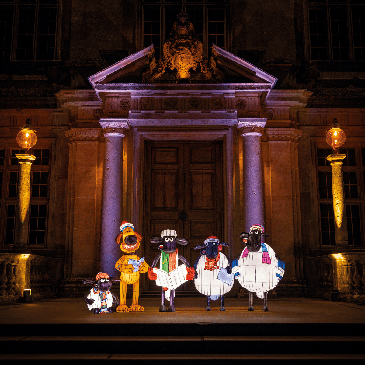 Shawn the Sheep and friends carol singing in front of Longleat House