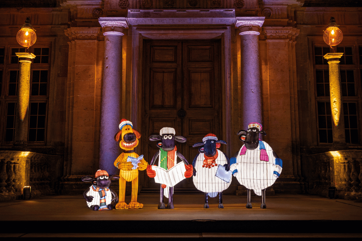 Shawn the Sheep and friends carol singing in front of Longleat House