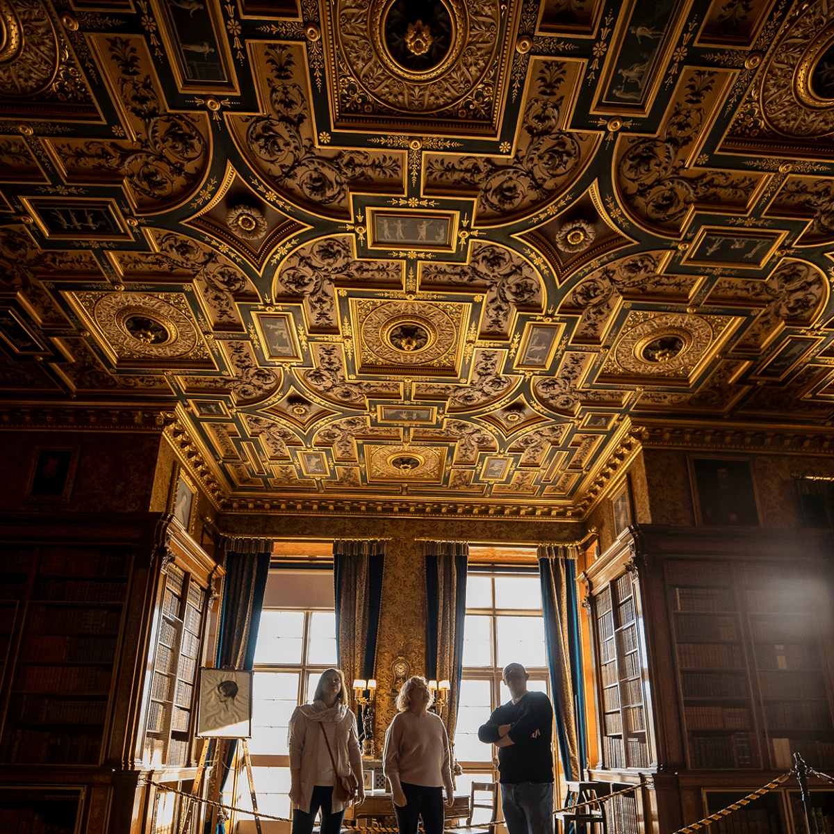 Guest admire the grand ceiling whilst on a tour of Longleat House