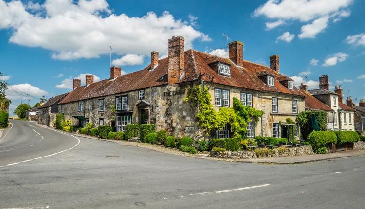 The Lamb Hindon - A country pub on the corner of a road, with climbing plants and a red tiled roof