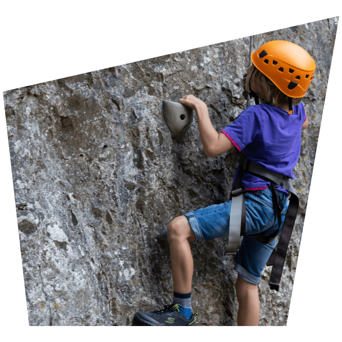 A young visitor climbs one of the rock formations at Cheddar Gorge