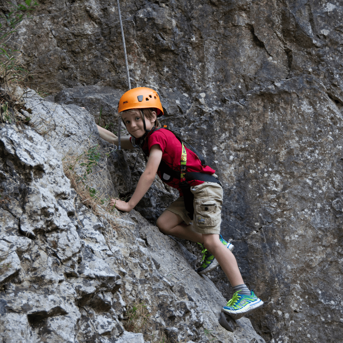 A young visitor climbs one of the rock formations at Cheddar Gorge