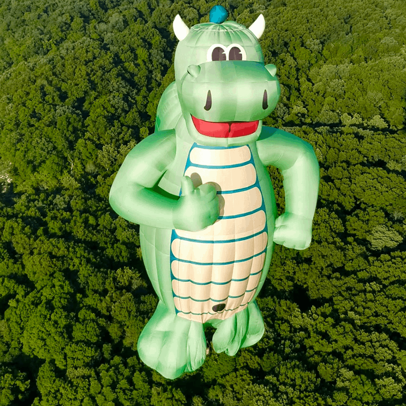 A balloon shaped like a green, smiling dragon